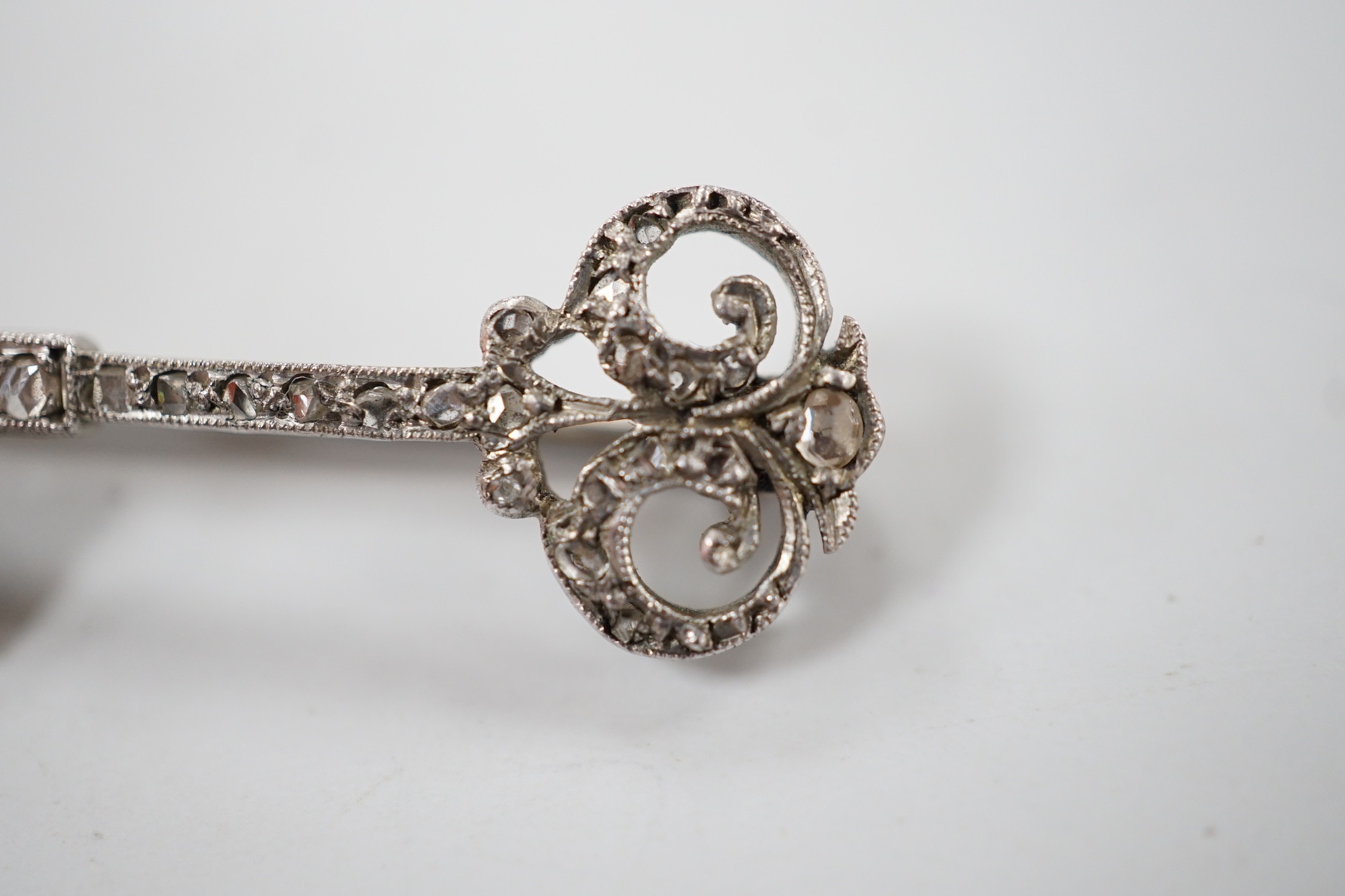 An early 20th century white metal and rose cut diamond set 'key of the door' brooch, 33mm, gross weight 2.1 grams.